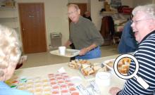 Wayne Matter has a good laugh as he fills his plate during the community dinner on Oct. 15.