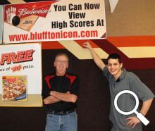 John Dailey and Derek Dukes show off the Bluffton Icon poster at Southgate Lanes