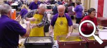 Lions Club members serving barbecue chicken dinners